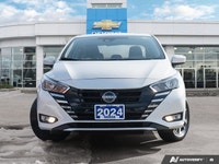 The former daily rental 2024 Nissan Versa SV, dressed in an eye-catching Aspen White TriCoat, presen... (image 1)