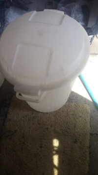 Plastic garbage bin with lid.