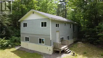 Tucked away on a peaceful country road, this charming split-entry home offers exceptional privacy an...