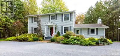 Tucked behind a privacy hedge & surrounded by mature trees, this distinguished two-story home offers...