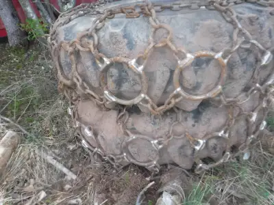 TWO 18.4x34 skidder tires and one set of chains,mounted on Timberjack or Treefarmer 12 bolt rims. If...