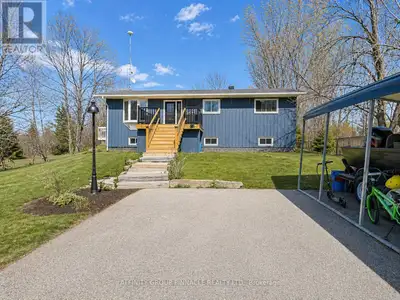 Charming raised bungalow in a peaceful country setting! Set well back from the road, the private fro...
