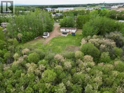 Rare opportunity to own a secluded private oasis right within the town limits of La Crete! Set on 1....