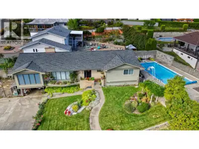 Charming LAKEVIEW HOME with great SWIMMING POOL. Custom-built and set on a prime corner lot, this ho...