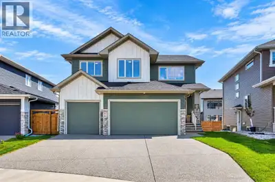 Welcome to this stunning, move-in ready Triple garage, Open to below living area, Main floor bedroom...