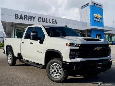 The 2026 Chevrolet Silverado 2500HD Work Truck in pristine white and equipped with a rugged 4x4 driv...