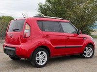 The 2011 Kia Soul 2u in a vibrant red with front-wheel drive is a vehicle built for handling the dem... (image 2)