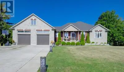 Stunning Country Bungalow on an amazing 1.44 acre lot, close to the lake. Walk in to the grand foyer...