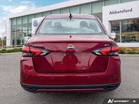 Designed for efficiency and confident urban navigation, this vibrant red 2024 Nissan Versa SV, is yo... (image 2)
