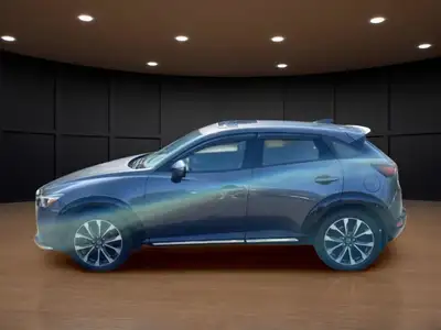 Get ready to conquer the roads with the 2022 Mazda CX-3 GT, a sophisticated gray SUV that combines a...