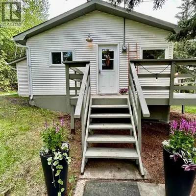 Escape to your own private retreat nestled in the trees. This updated 1 bed + den home features a st...