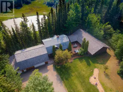 Private and spacious renovated log home with a shop on 3.96 acres, nestled on a treed lot with a pon...