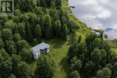 Welcome to your private paradise on nearly 4 acres of serene, tree-lined waterfront along beautiful...