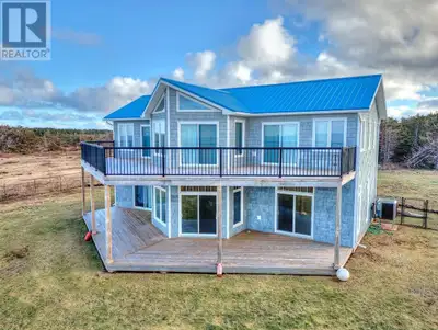 Custom designed oceanfront retreat on four plus acres in picture-square Priest Pond. Main level: rec...