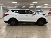 Powerful confidence wrapped in Frost Whitethis 2018 Hyundai Santa Fe 2.4 SE All-Wheel Drive SUV is e... (image 4)