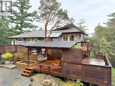 Privately tucked away on a serene acreage of natural beauty, this special property offers a rare ble...