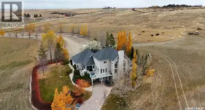 Situated on a picturesque landscape with prairie & water views, along with approximately 70 acres of...