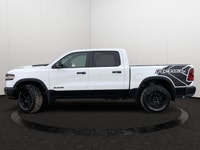 This *2025 Ram 1500 Rebel Crew Cab 4x4* in *Bright White* represents the newest chapter of Ram perfo... (image 1)
