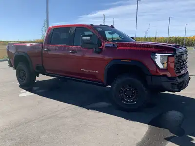AMVIC Licensed Dealer The 2026 GMC Sierra HD AT4X AEV Edition in Volcanic Red Tintcoat is engineered...
