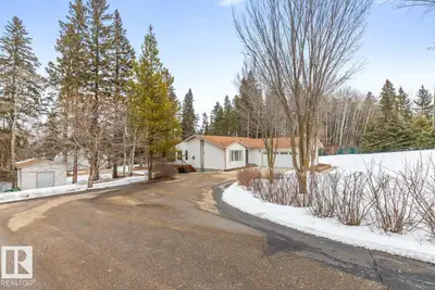 Tucked among the trees in Willow Lake Estates, this meticulously maintained, original-owner bungalow...