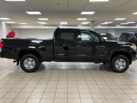 The black paint drinks in daylight like ink, casting sharp reflections across muscular fenders while... (image 6)