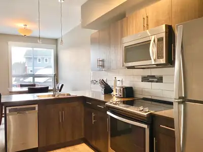 This modern semi-furnished 2-bedroom 2-bathroom townhouse is located at 305-110 Baxter Landing, Kiti...