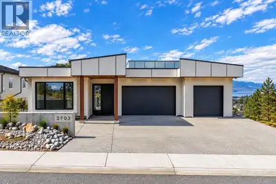 This custom modern residence offers rare, uninterrupted lake-to-lake views and was built without com...