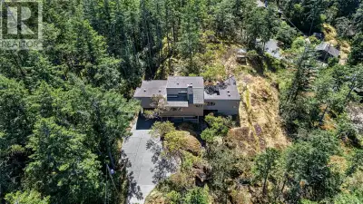 Nestled in a private, sun-drenched setting, this spectacular West Coast home features hardwood floor...
