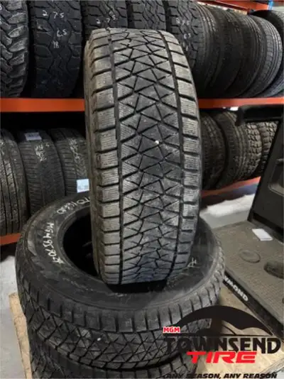 SET OF FOUR USED BRIDGESTONE BLIZZAK DMV2 WINTER TIRES WITH ABOUT 50% TREAD REMAINING. SOLD AS SET O...