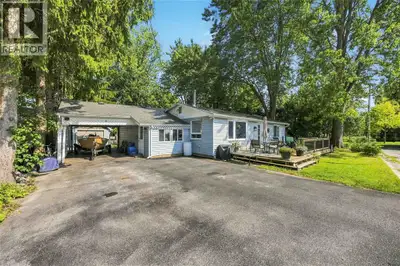 Welcome to this charming one-floor home offering a partial water view from the front deck and plenty...