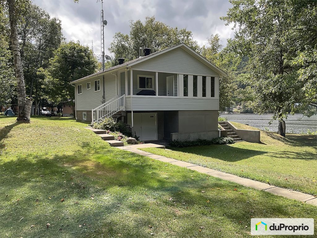 $489,000 - Cottage for sale in Mandeville — photo 1
