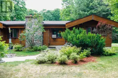 This cozy, Western Red cedar, double tongue and groove U-shaped log bungalow is nestled on a 14-acre...