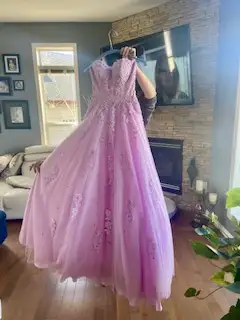 This dress has been worn once and has been dry cleaned.