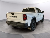 The 2026 Ram 1500 Rebel 4x4 Crew Cab 57 Box is ready to impress with its striking white finish and r... (image 4)