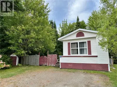 Tucked away at the very back of the neighborhood and backing onto a peaceful wooded area, this beaut...