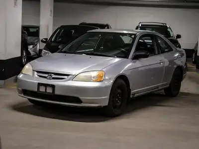 Experience the enduring charm of the 2002 Honda Civic LX, a stylish coupe dressed in sleek silver an...