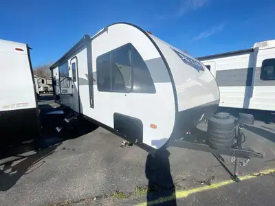 The Wildwood X-Lite 24VIEW floorplan offers standard hung fiberglass exterior and solid surface coun...