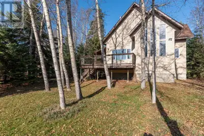 Enjoy year-round living in this spacious 1,900+ sq. ft. cabin set on a picturesque waterfront lot at...