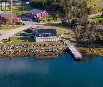 The ocean is calling you home! Welcome home to 549 Sober Island Road. This impressive oceanfront pro...