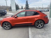 The 2023 Porsche Macan AWD, finished in eye-catching Papaya Metallic, brings true sports car DNA int... (image 3)