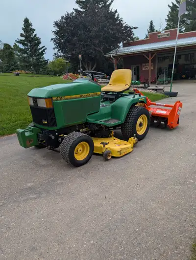 John Deere 425 all wheel steer with rototiller and mowing deck, View more