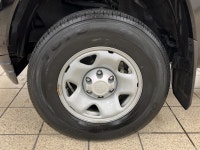 The black paint drinks in daylight like ink, casting sharp reflections across muscular fenders while... (image 8)