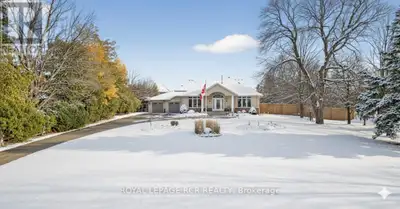 Executive bungalow on nearly an acre in town ! Welcome to unparalleled luxury in this custom stone a...