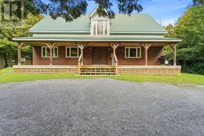 Hidden from the road behind mature cedars, this distinctive country home sits on a private 0.63 acre...