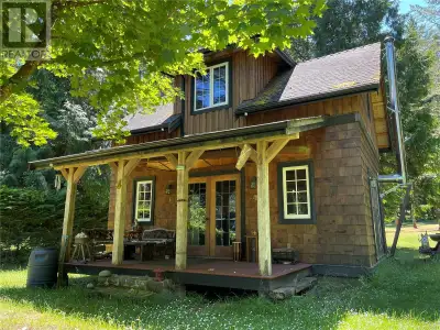 Stunning Walk-On WATERFRONT with a park-like setting featuring a well built Cottage on beautiful Mud...