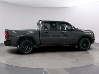 Meet the 2026 Ram 1500 Rebel 4x4 Crew Cab 57 Box: a commanding presence in a refined gray shade. Bui... (image 5)