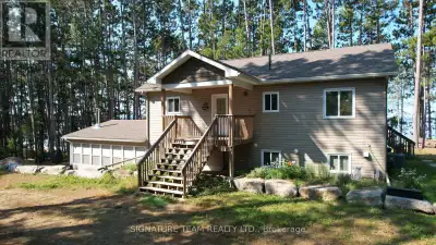 A Round Lake Waterfront Property, with amazing sunsets from the main deck and sand beach that is ove...