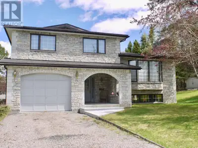 This must-see custom stone split level home offers up 3 bedrooms, 2.5 baths on a 214.05’ x 125’ (3 l...
