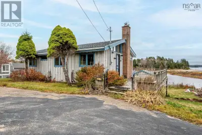 This compact home boasts over 100 feet of waterfront on a tidal pond, perfect for leisurely kayak or...