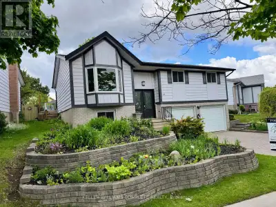 Welcome to this beautifully renovated raised bungalow, ideally situated on a charming tree-lined str...